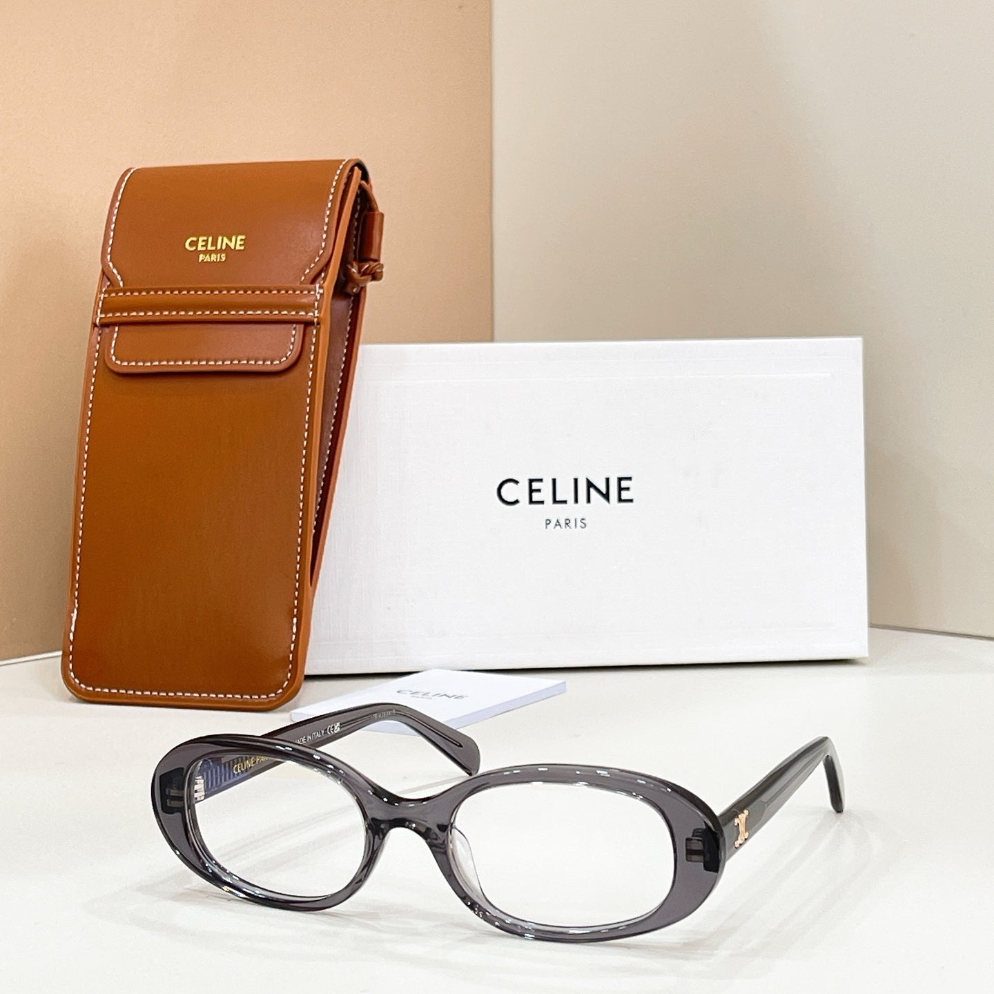 Celine eyeglasses with dark frames and clear lenses, shown beside a brown leather case