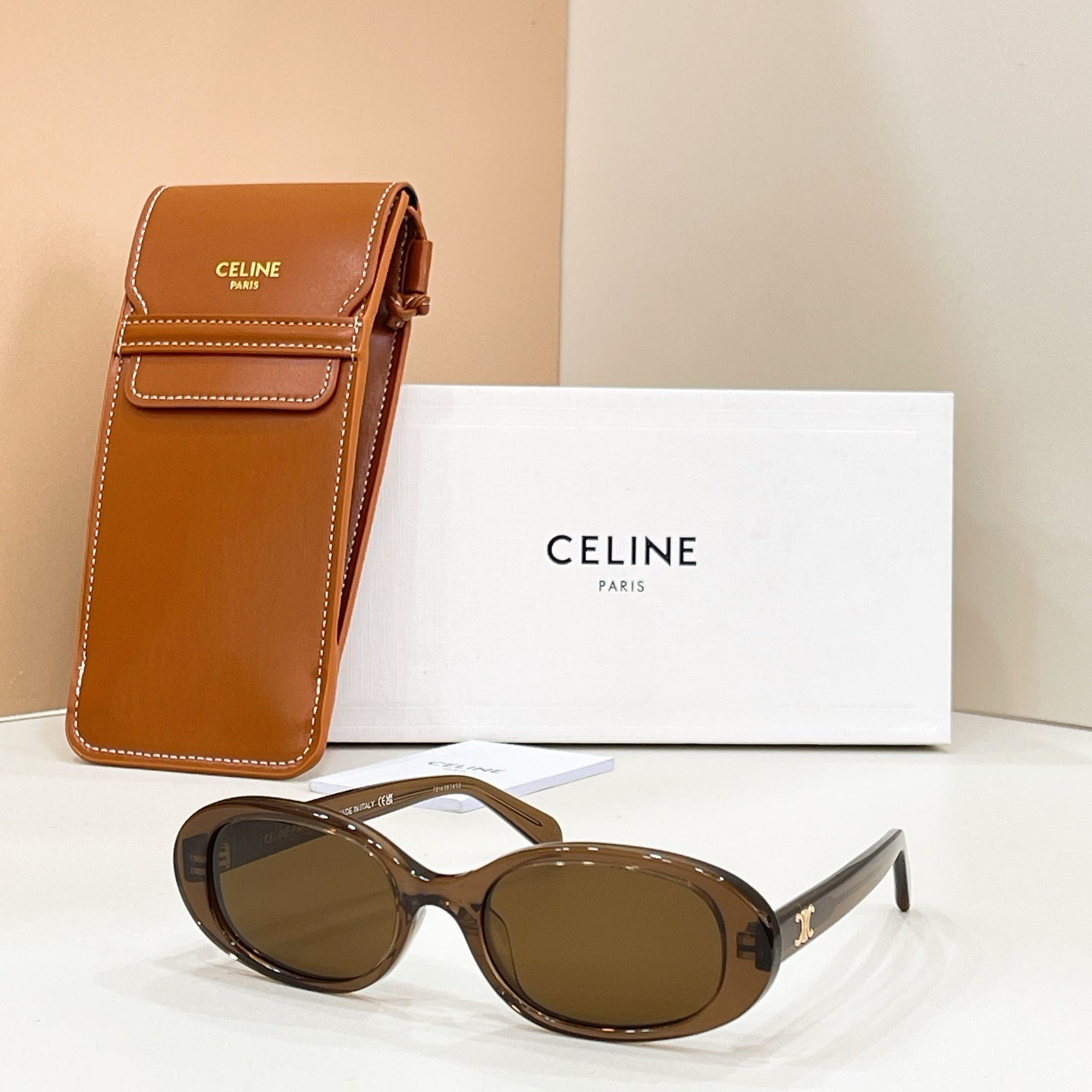 Celine sunglasses with brown lenses and dark frames, with a brown leather case