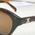 Black tortoiseshell sunglasses temple with gold logo detail