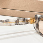 Bvlgari eyeglasses, side view close-up of clear gray frame and gold-tone hinge
