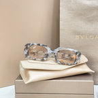 Bvlgari eyeglasses, clear gray marbled frames with gold-tone detail