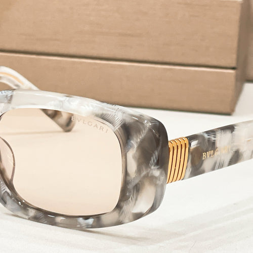 Bvlgari eyeglasses, close-up of clear gray marbled frame and gold-tone hinge