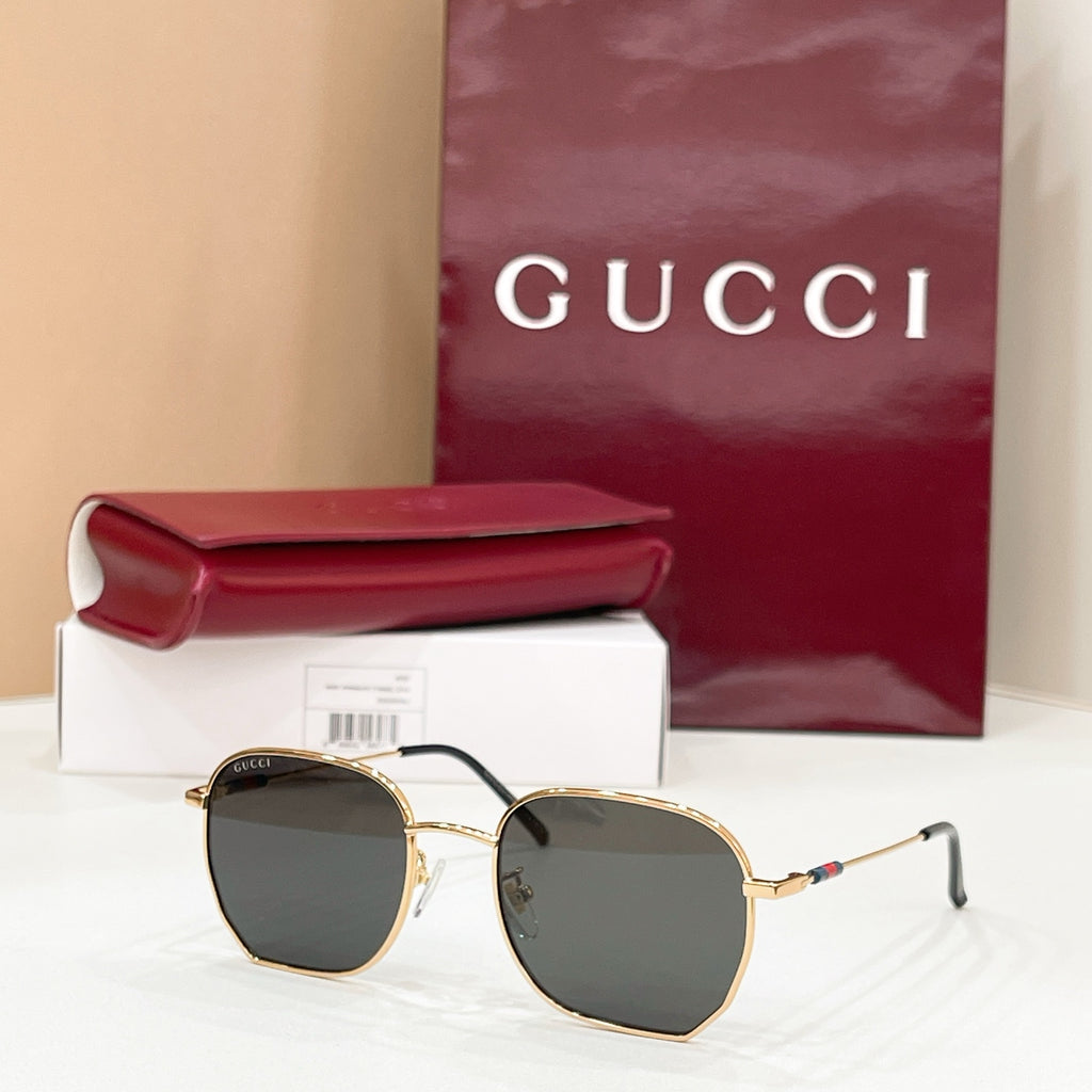 Sunglasses with gold octagonal frame and dark gray tinted lenses