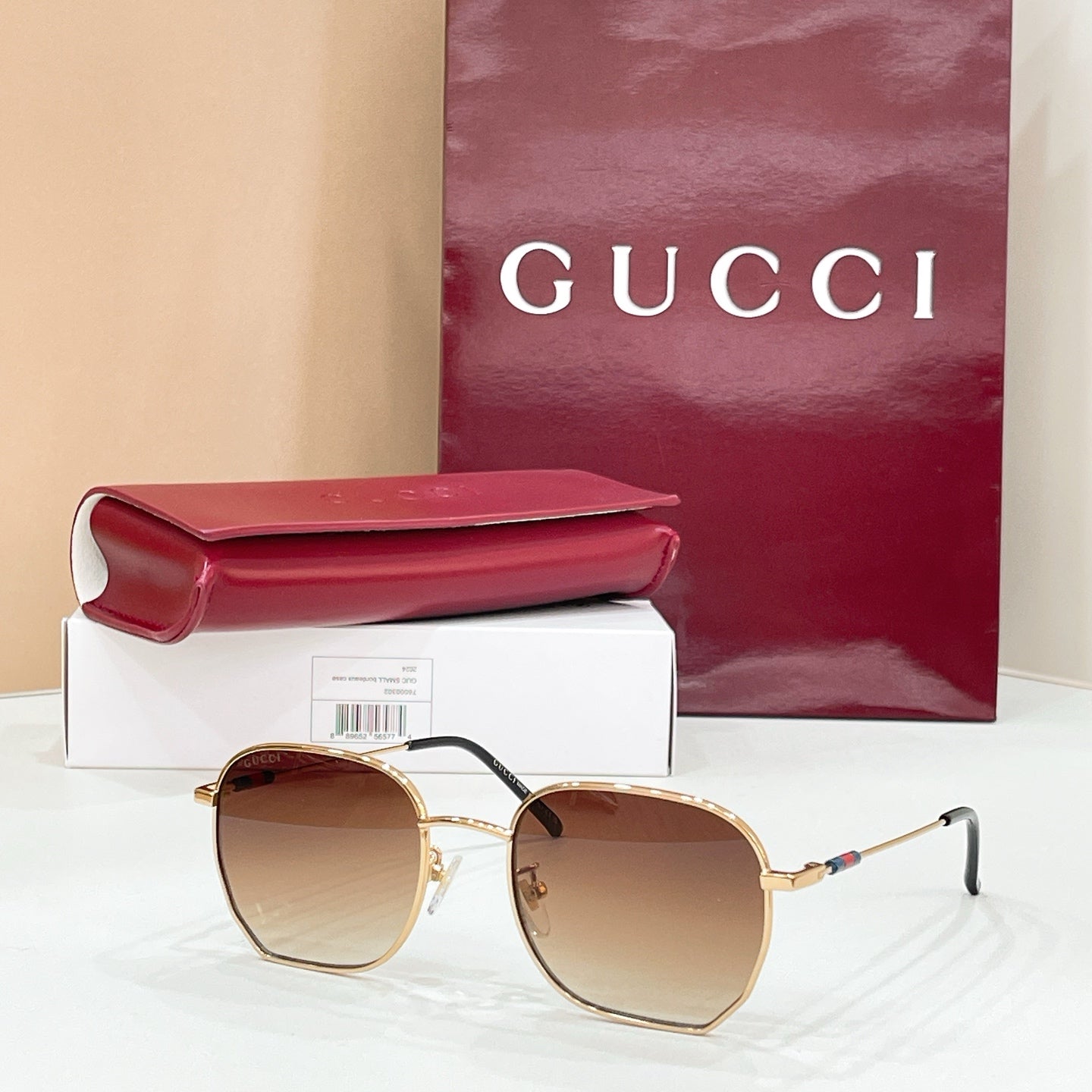 Sunglasses with gold octagonal frame and brown tinted lenses