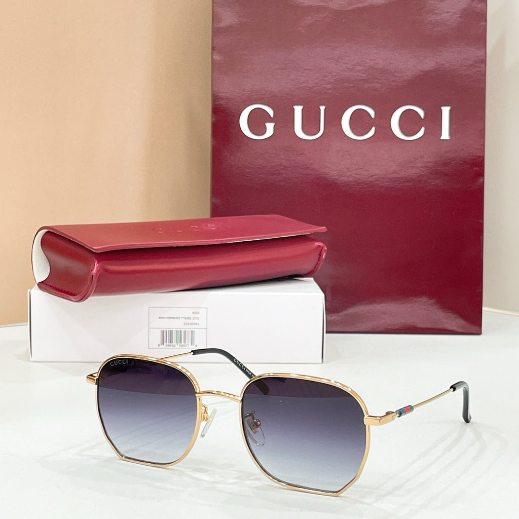 Sunglasses with gold octagonal frame and blue tinted lenses