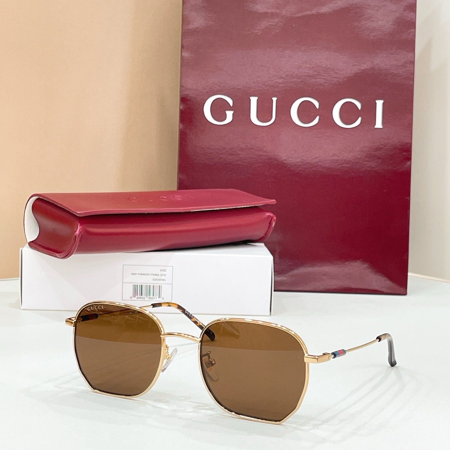Sunglasses with gold octagonal frame and amber tinted lenses