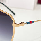 Aviator sunglasses temple with gold-tone metal arm and multicolor stripe detail