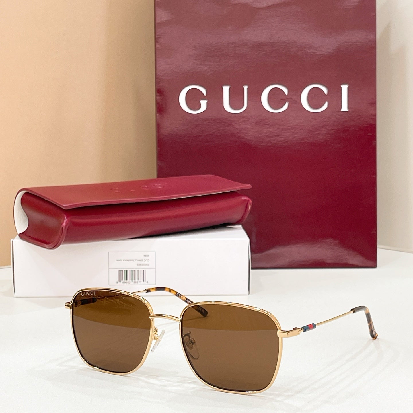 Gold-tone aviator sunglasses with dark brown gradient lenses and double-bridge frame