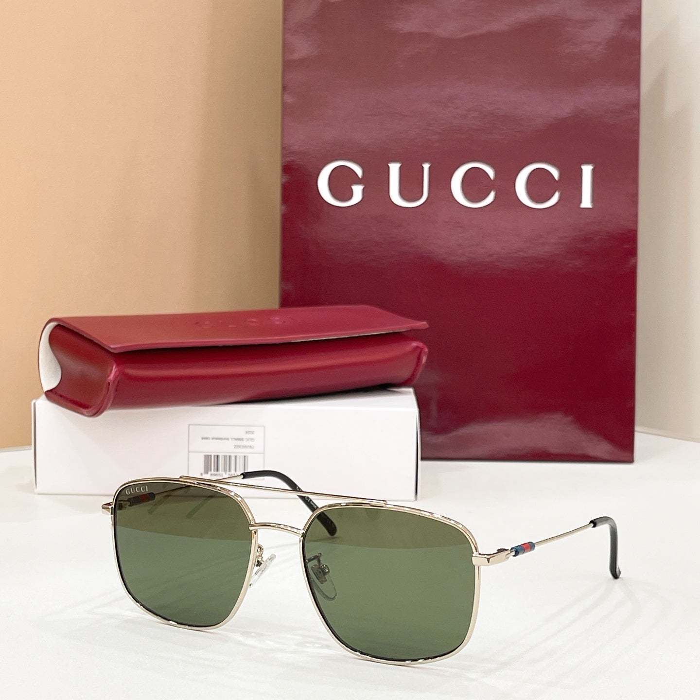 Gold-frame round sunglasses with green-tinted lenses, slim arms and temple hinges
