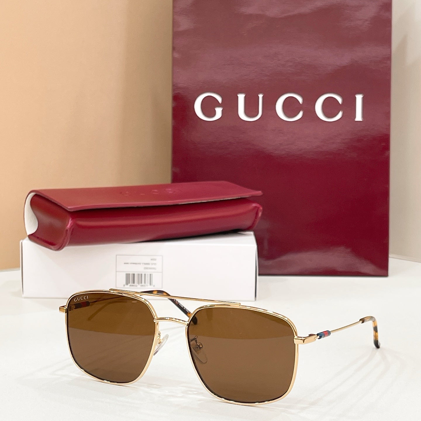 Gold-frame round sunglasses with brown lenses, slim arms and temple hinges