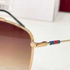 Gold eyeglass frame with temple hinge and blue/red enamel accent on the arm