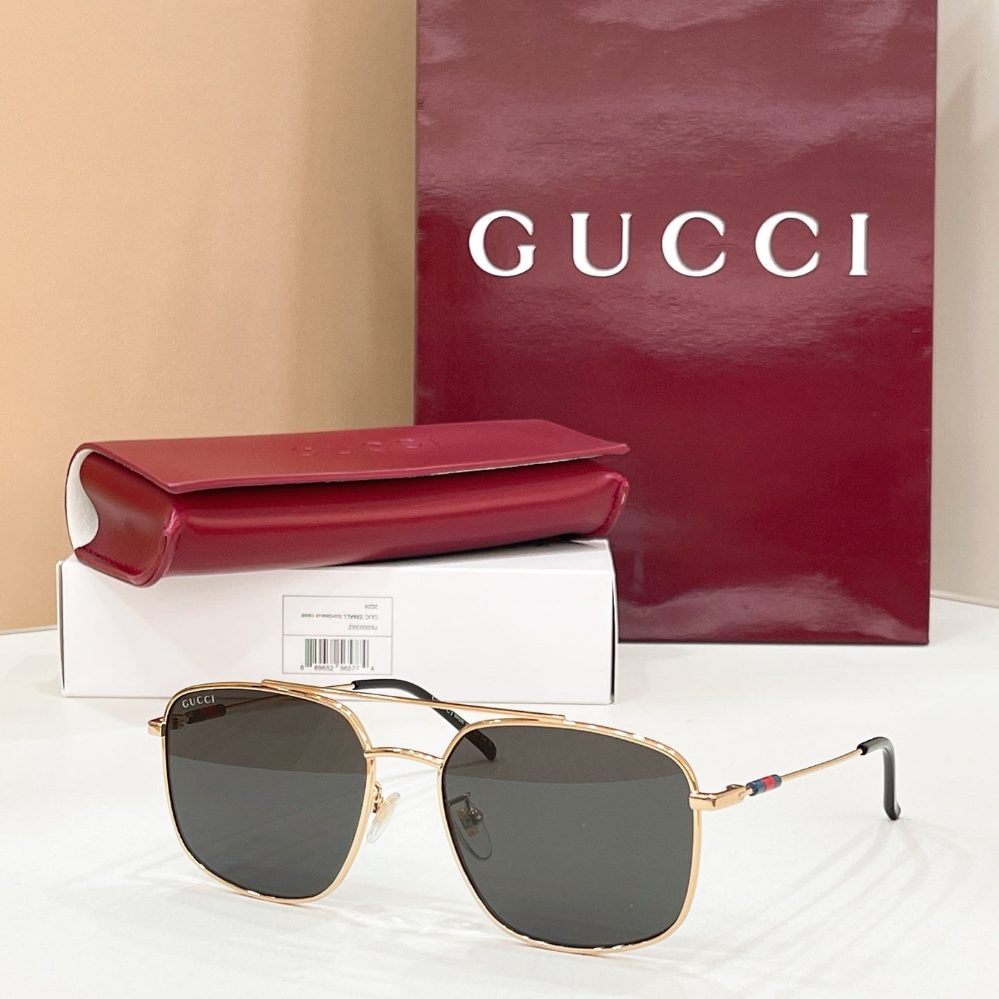 Gold-frame round sunglasses with dark gray lenses, slim arms and temple hinges