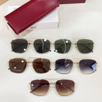 Assorted sunglasses with gold frames and varying lens tints, with red hard case