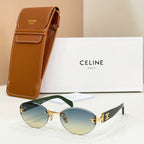 Round-to-cat-eye sunglasses with gold frame, green mirrored lenses, and brown temple tips.