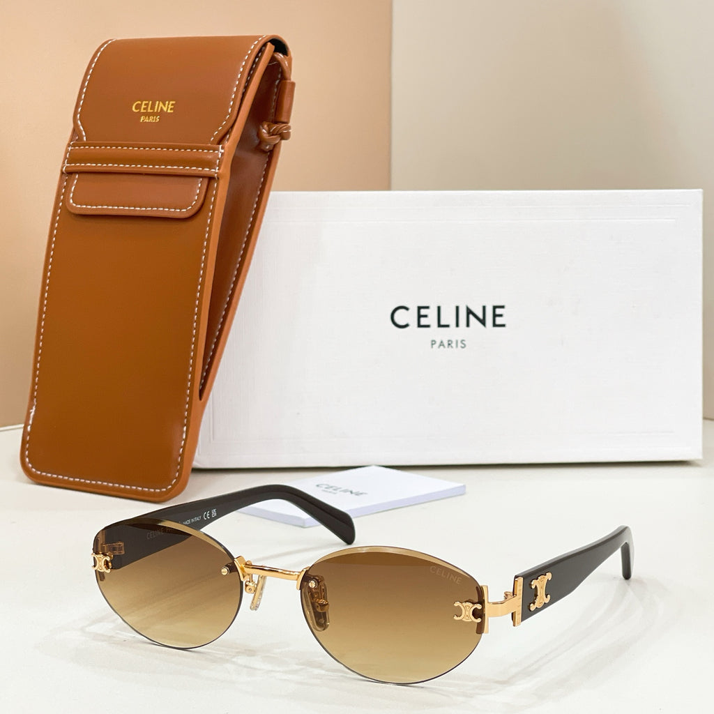 Round-to-cat-eye sunglasses with gold frame, amber mirrored lenses, and black temple arms.