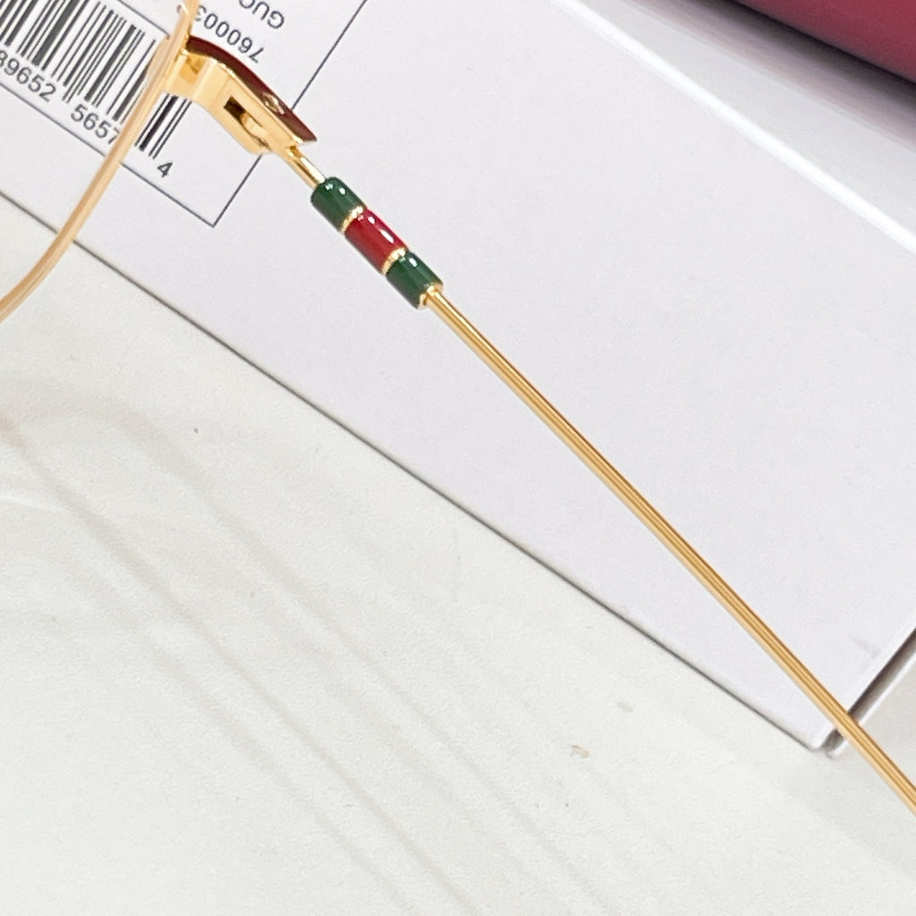 Gucci gold eyeglass temple with multicolor web stripe and hinge detail