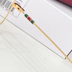 Gucci gold eyeglass temple with multicolor web stripe and hinge detail