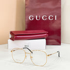 Gucci eyeglasses with clear lenses, gold tone frame and dark temple arms