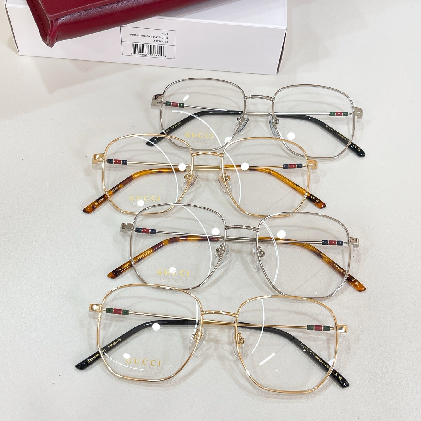 Gucci eyeglasses set with clear lenses, multiple gold and dark frames