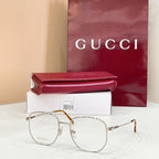 Gucci metal eyeglass frame with clear lenses, gold tone and tortoiseshell temple
