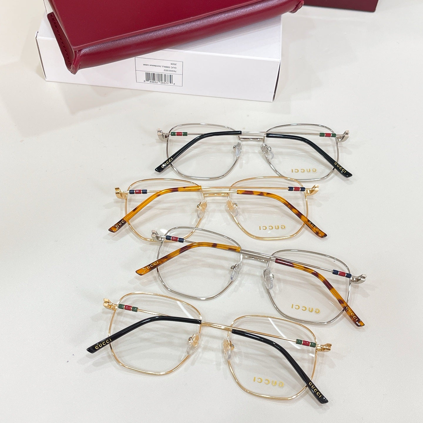 Gucci eyeglasses set with clear lenses, black and gold metal frames
