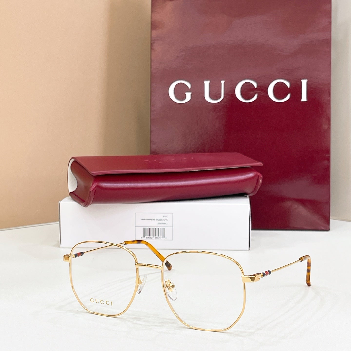 Gucci metal eyeglasses with clear lenses, gold tone frame and black temple tips