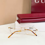 Gold eyeglasses with clear lenses and tortoise-pattern arms, side view