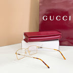 Gold metal eyeglasses with clear lenses and tortoise-pattern temples