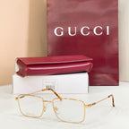 Gold metal eyeglasses with clear lenses and orange-brown tortoise temples