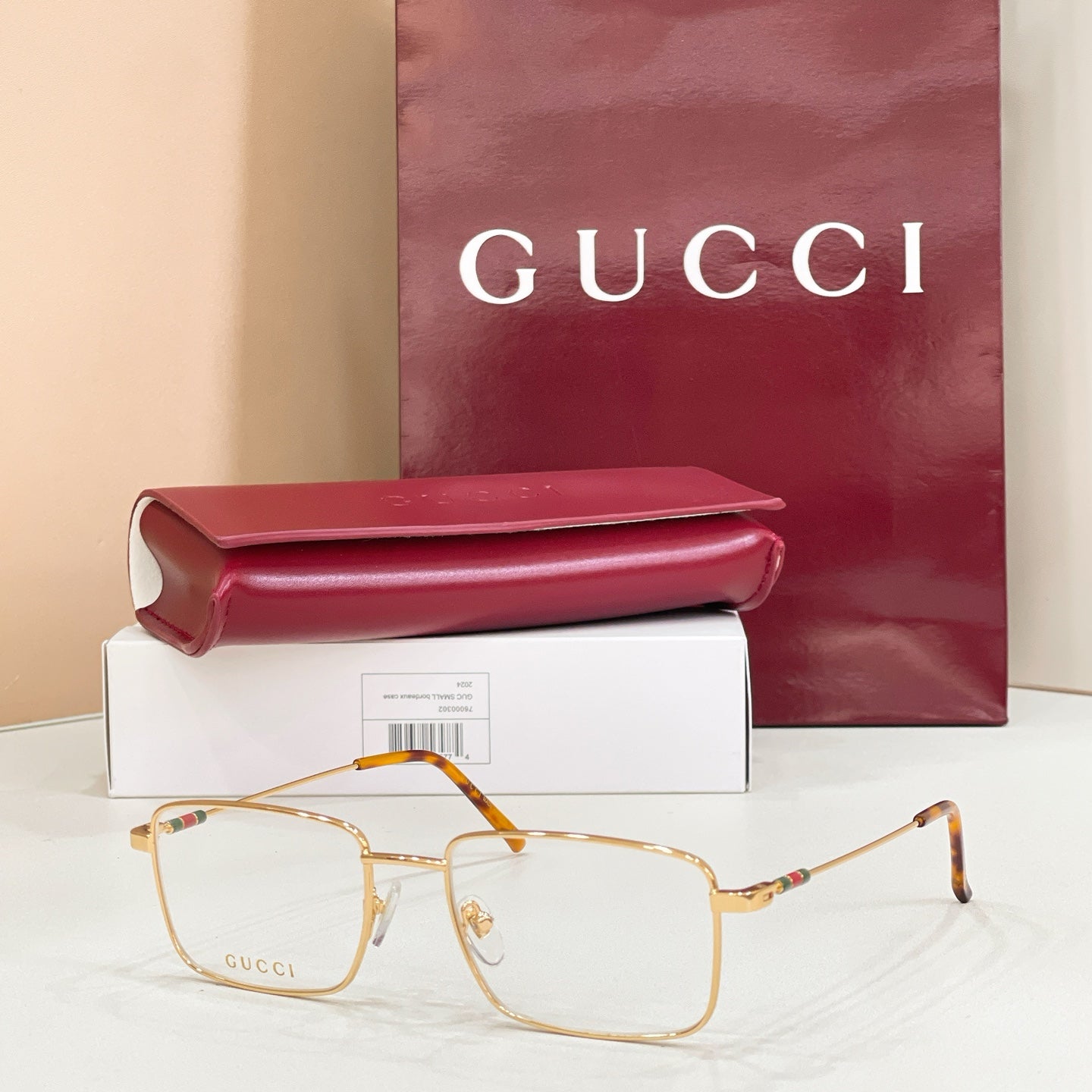 Gold metal eyeglasses with clear lenses and orange-brown tortoise temples