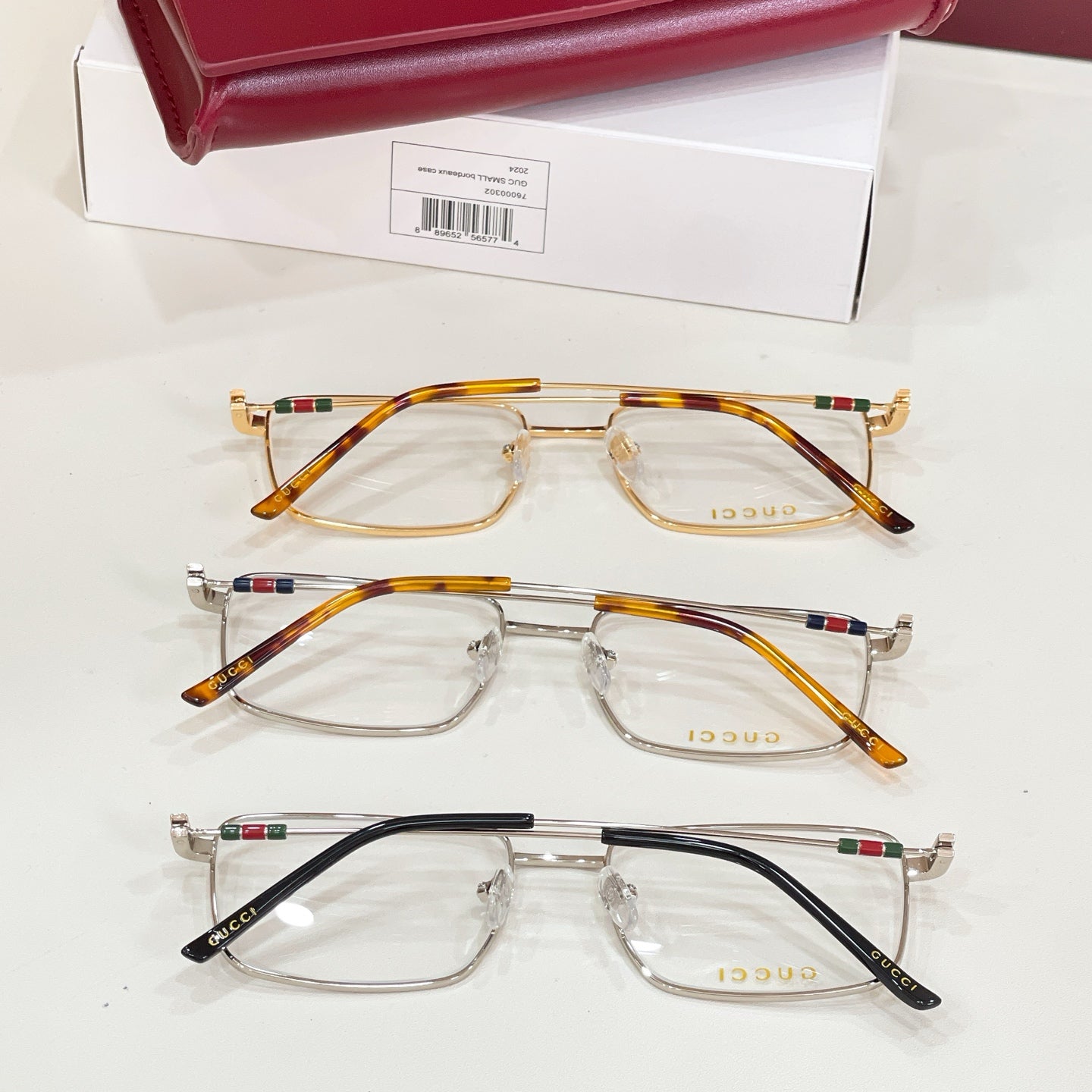 Three eyeglasses pairs with clear lenses: gold, tortoise, and black frames