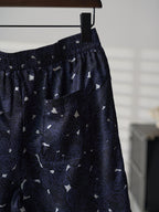 Navy skirt side view with gathered waist and allover swirl print