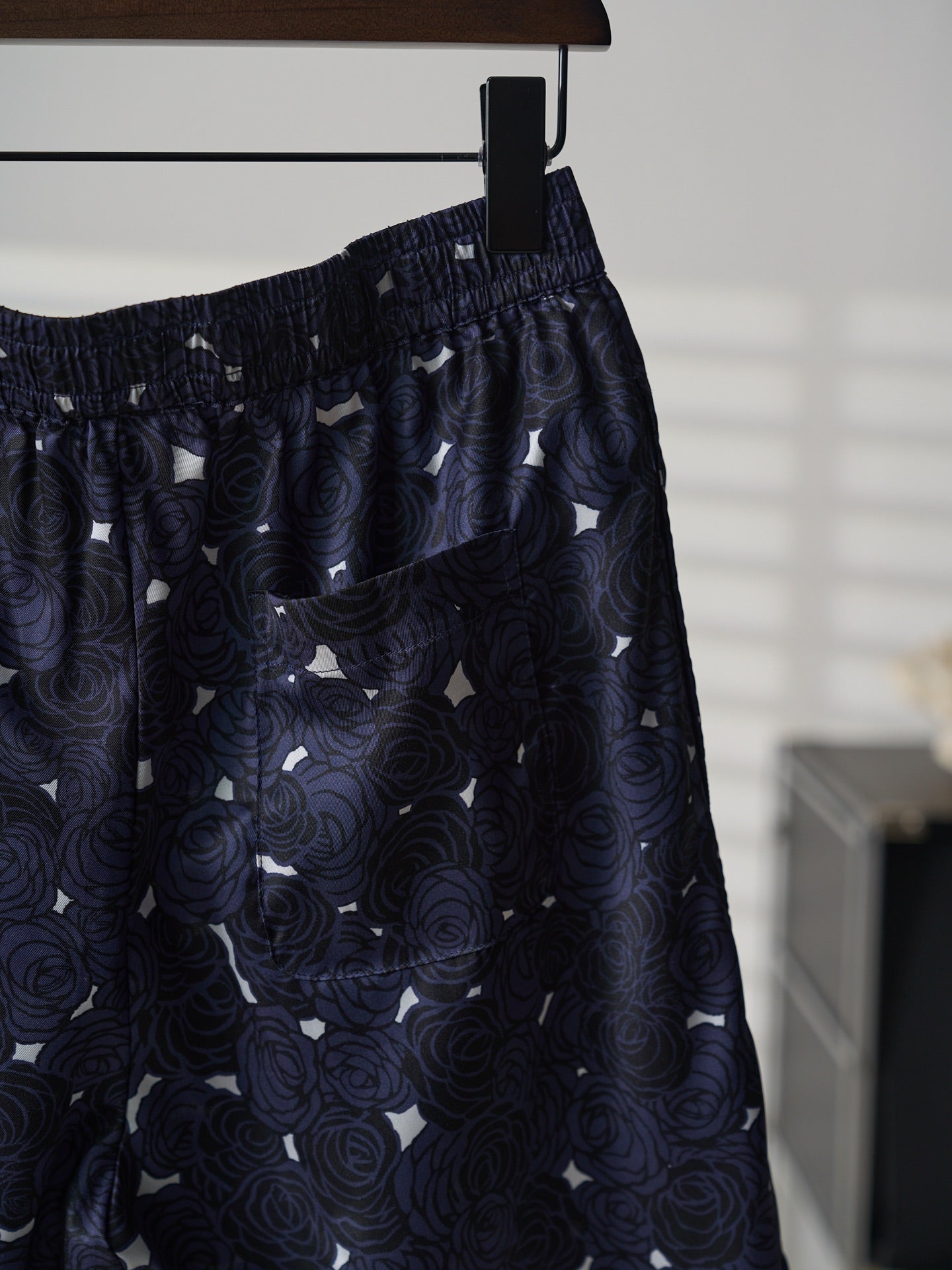 Navy skirt side view with gathered waist and allover swirl print