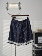 Navy patterned skirt on hanger with elastic waistband and curved hem trim