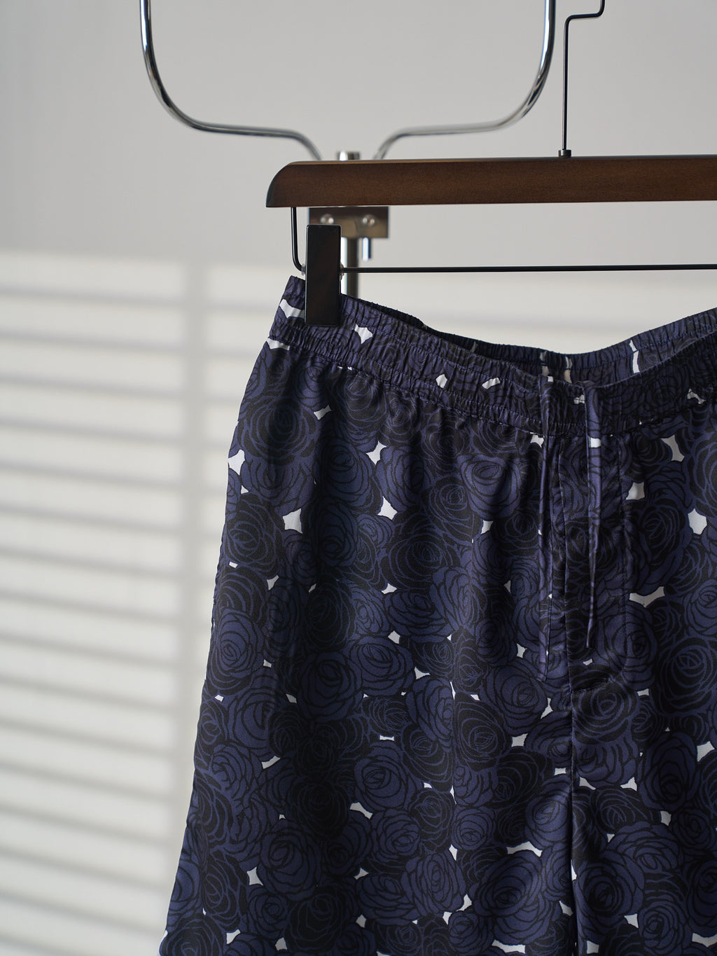 Navy skirt front view on hanger with elastic waistband and keyhole trim