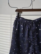 Navy skirt front view on hanger with elastic waistband and keyhole trim