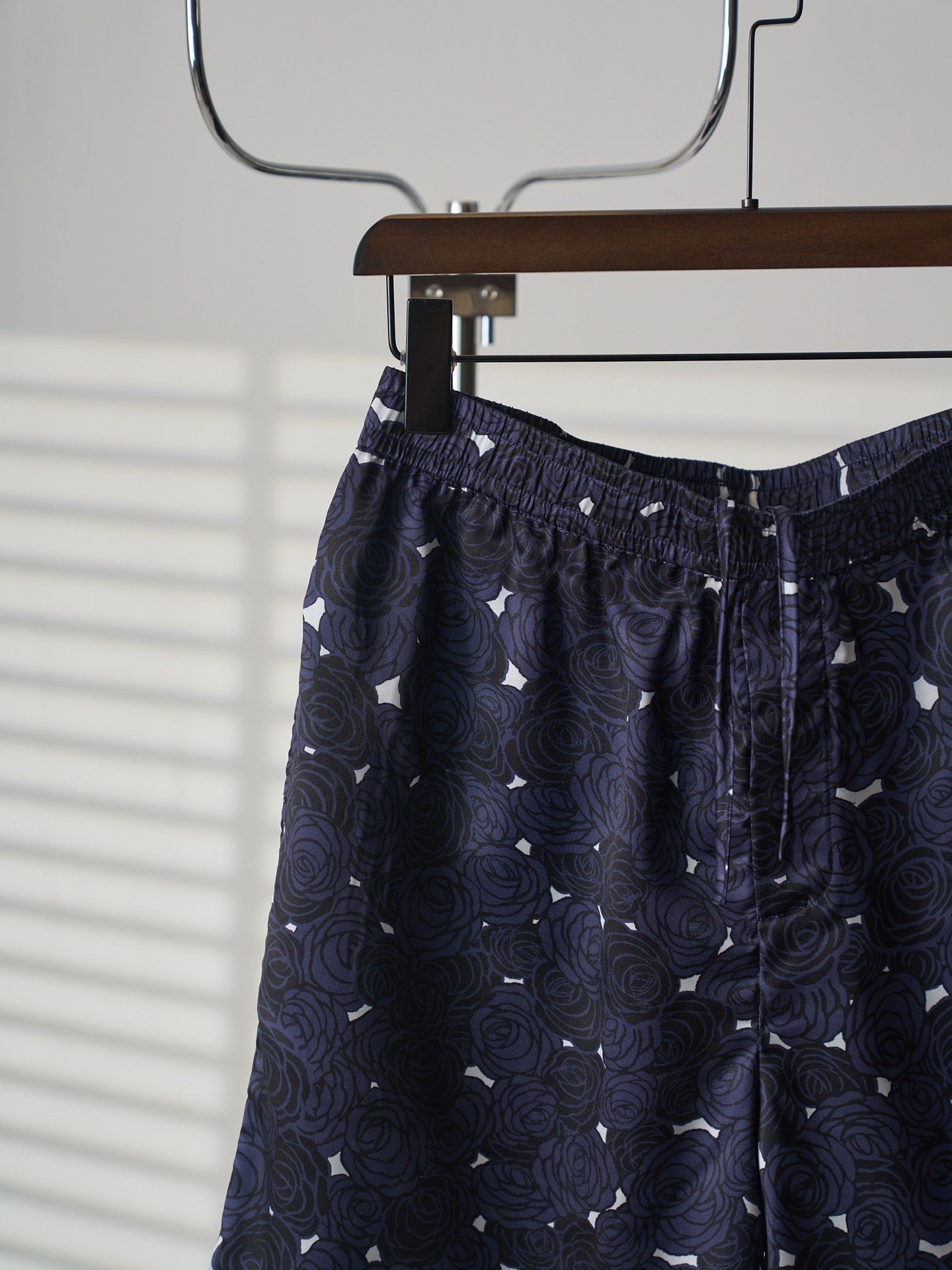 Navy skirt front view on hanger with elastic waistband and keyhole trim
