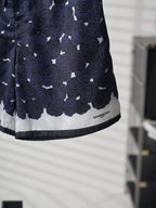 Navy skirt hem detail with white trim and GIVENCHY logo