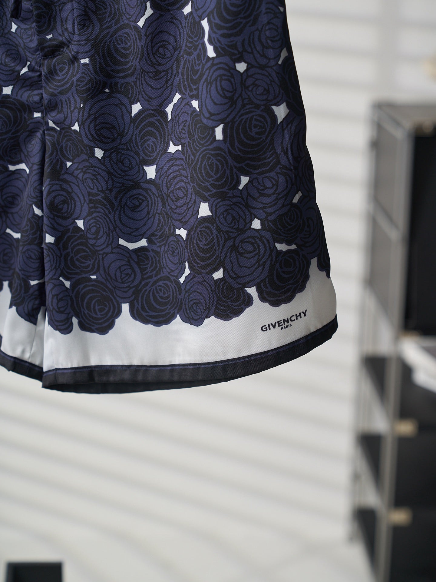 Navy skirt hem detail with white trim and GIVENCHY logo