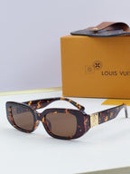 Louis Vuitton glasses, tortoiseshell frames with dark lenses and gold hinge detail