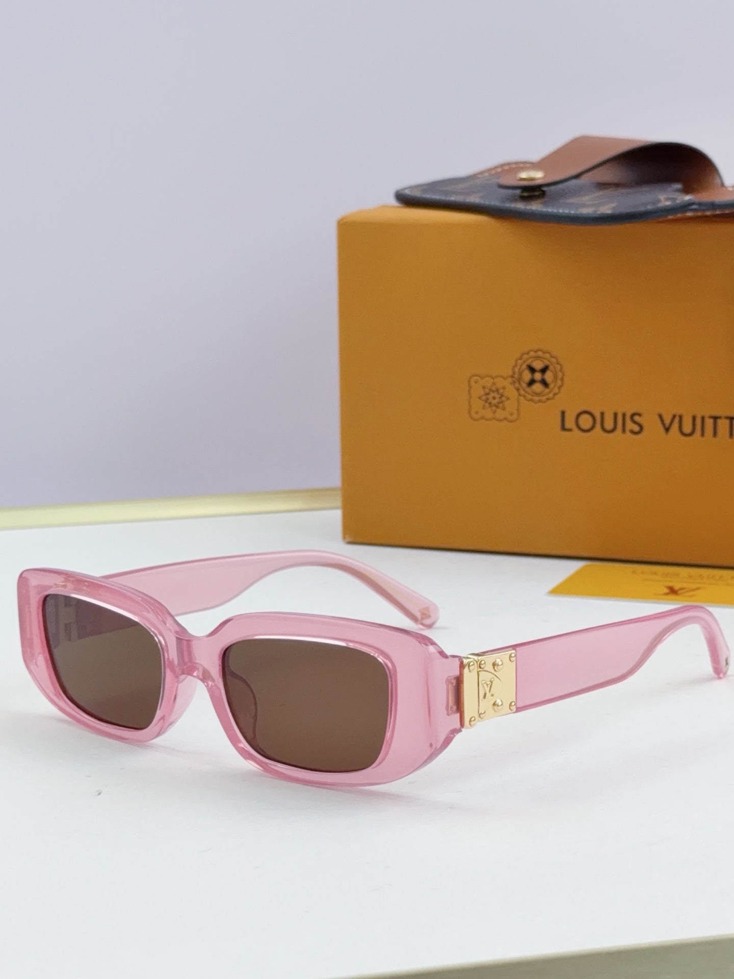 Louis Vuitton glasses, pink frames with dark lenses and gold bridge detail