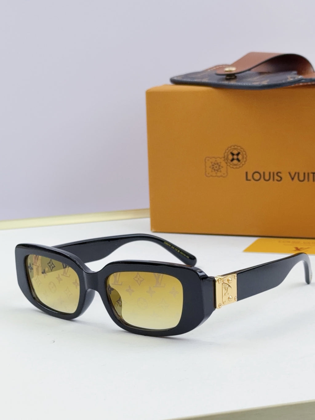Louis Vuitton glasses, black frames with amber-yellow lenses and gold bridge detail