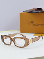 Louis Vuitton eyeglasses with light brown frames and gold logo detail