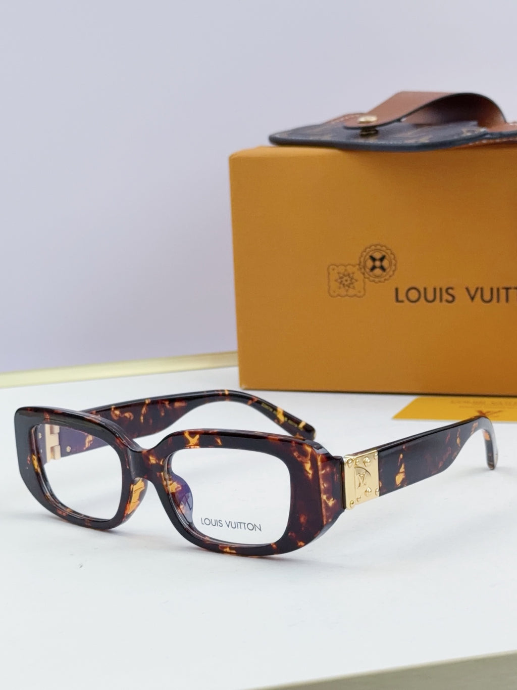 Louis Vuitton eyeglasses with dark tortoise frames and gold logo detail