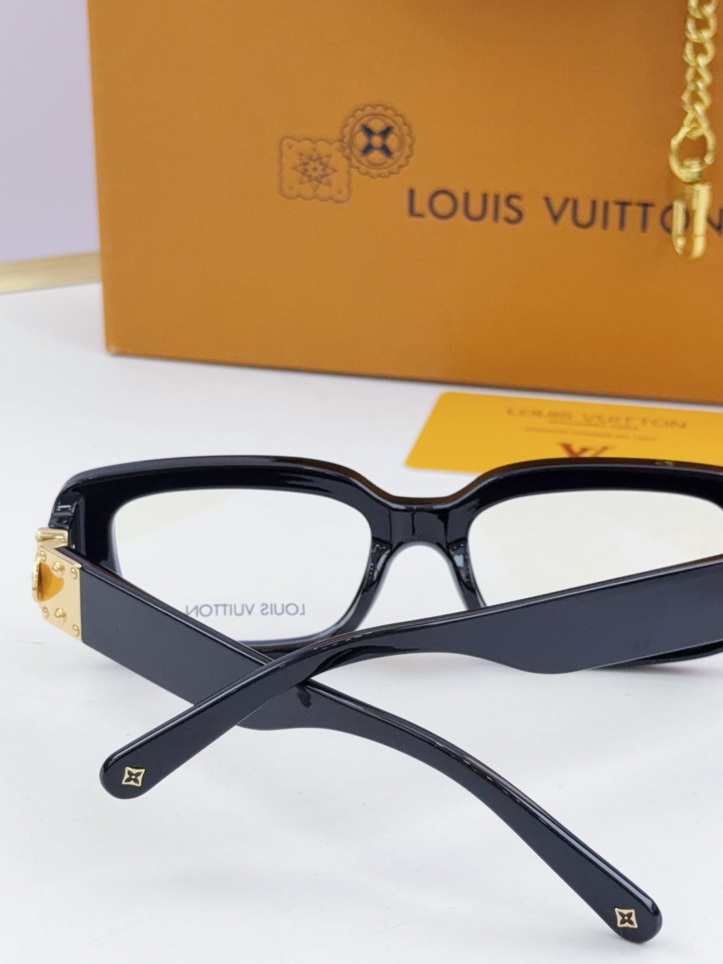 Louis Vuitton eyeglasses with dark frames and gold hinge hardware