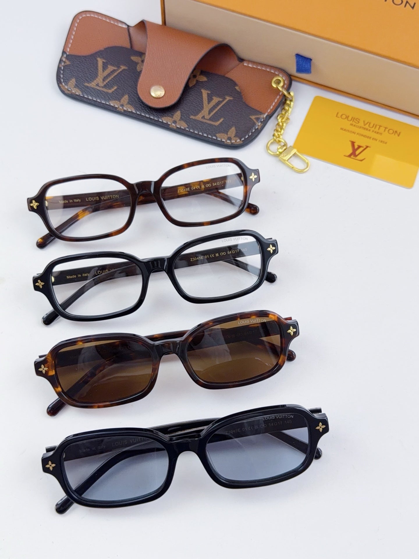 Louis Vuitton glasses set with four frames, leather case, and gold charm