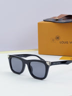 Louis Vuitton sunglasses with dark frames and black lenses, gold-tone details