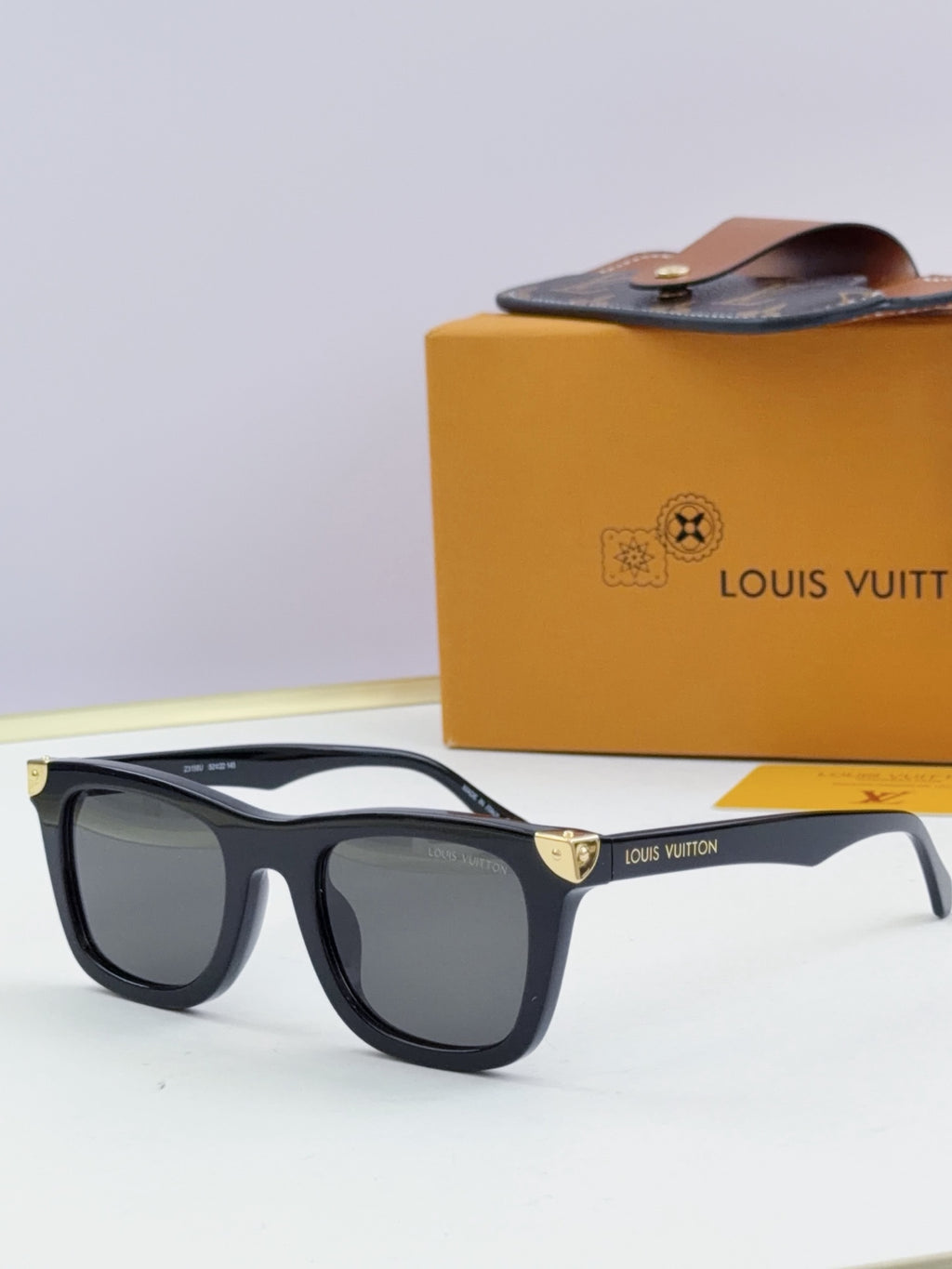 Louis Vuitton sunglasses with black frames and dark gray lenses