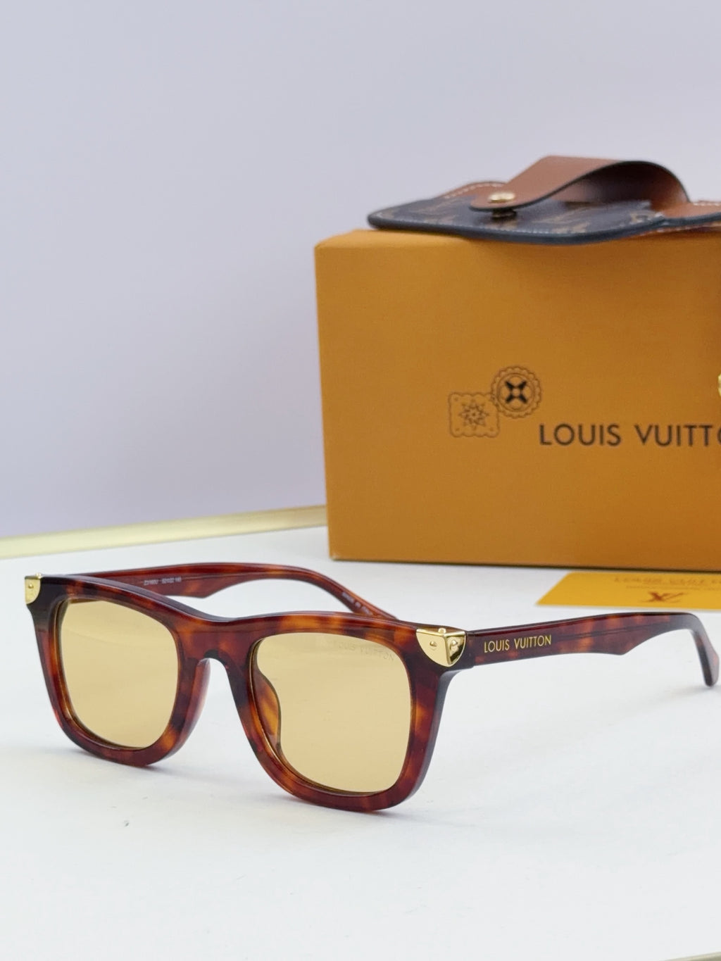 Louis Vuitton sunglasses with light tortoiseshell frames and amber lenses