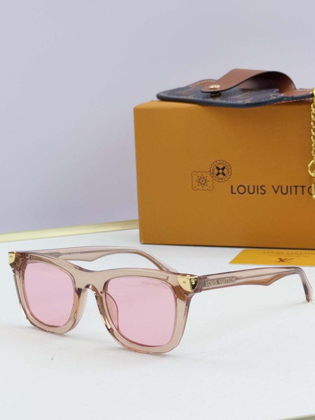 Louis Vuitton sunglasses with pale pink frames and pink tinted lenses